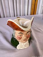 Front three-quarter view showing character face, hat spout and coloration