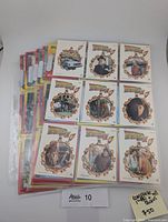 Front view of nine character stickers in top sleeve with additional sleeved cards behind