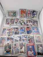 Overview of 28 rookie baseball cards in sleeves/top loaders