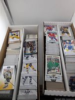 Two long boxes filled with upright hockey cards, visible O-Pee-Chee Marquee Rookies and League Leaders fronts