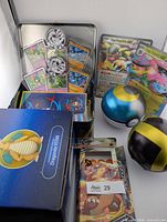 Overview of Dragonite VSTAR box, Poké Ball tins, silver storage tin with cards, jumbo cards