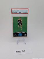 Front view of encapsulated 1970 O-Pee-Chee Bobby Orr Hart Trophy card in PSA holder