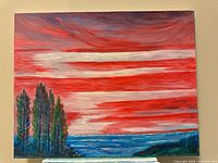 Full view of seascape painting showing red sky, ocean, trees, landscape orientation