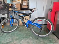 Side view of full bicycle with basket, kickstand and 26-inch wheels visible