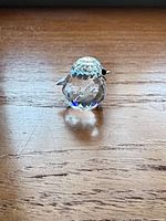 Front view of faceted crystal bird showing shape and clarity