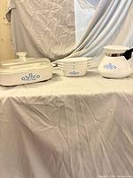 Full lot showing casserole with lid, four bowls, and percolator