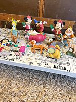 Group shot of all 14 Disney ornaments on tabletop