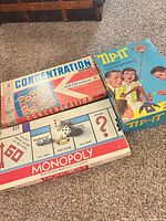 Group shot of Monopoly, Concentration, Tip-It boxes