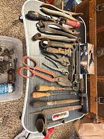 Full view of assorted hand tools laid out on table
