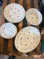 Group view showing all Finlandia pieces including platter, bowl, dinner plates, side plates