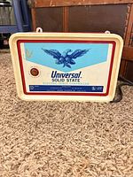 Front view showing Universal Solid State branding, eagle graphic, output indicator