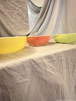 Side view of three nested Pyrex mixing bowls showing exterior colors