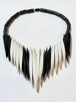 Full view of necklace arranged in circle showing alternating black and white slices