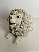 Full view of porcelain faience lion figurine crouching