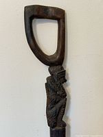 upper handle and carved monkey figure