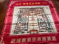 Full view of scarf displaying red border and full Forbidden City plan