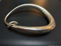 Full view of oval sterling silver bangle showing overall shape