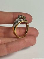 Side view of ring showing gold tone, cat motif, pavé stones