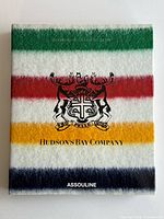 Front cover of Hudson's Bay Company book with multicolour stripes and crest
