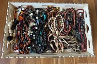 Tray full of assorted necklaces and view of tray table
