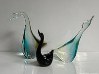 Group view of three Chalet Canada art glass swans