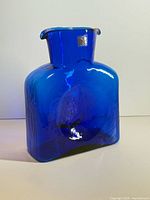 Front view of cobalt blue Blenko glass vase showing shape, color and original foil sticker