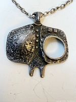 front view of textured pewter pendant with chain