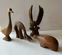 All four cedar animal sculptures grouped