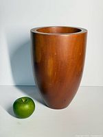 Front view teak champagne bucket next to apple for scale