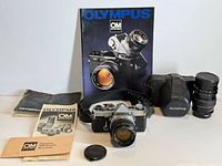 Full kit including camera with 50 mm lens, TeleSar 135 mm lens, manuals, catalogue, case, lens cap