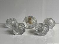 five snowball glass candleholders grouped