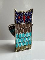 Front view showing owl face, scale pattern, colors