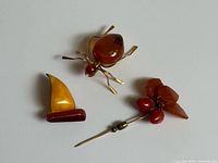 Group shot of three amber brooches