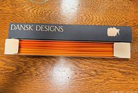 Open box displaying stacked orange tapers