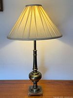 Full view brass lamp with shade attached
