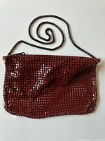 Full view of burgundy metal mesh bag with chain strap