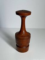 Full view of teak pepper mill upright