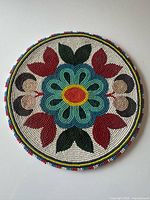 Front view of round beaded mat showing full pattern and colours