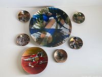 All seven copper enamel plates arranged for size comparison