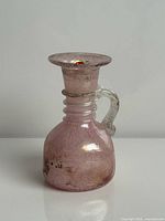 Front view of pink Murano scavo glass pitcher vase showing overall form and clear handle