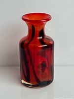 front view of red and black art glass vase