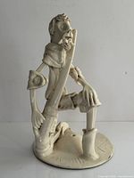 Full view of ceramic Don Quixote sculpture showing kneeling pose and lance