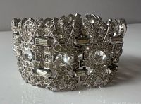 close view of bracelet front showing rhinestone panels and metal finish