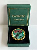 Paperweight in open presentation box showing brand on lid