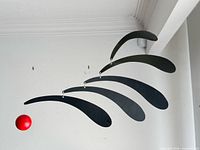 mobile showing black side with five blades and red sphere