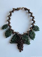 Full view of necklace showing aventurine leaves and grape clusters