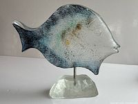 Left view of glass fish sculpture showing coloration and base