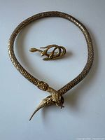 Necklace laid in closed loop with brooch above