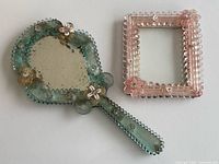 Green Murano hand mirror and pink Murano picture frame