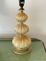 Close view of glass body detailing gold aventurine and ribbing